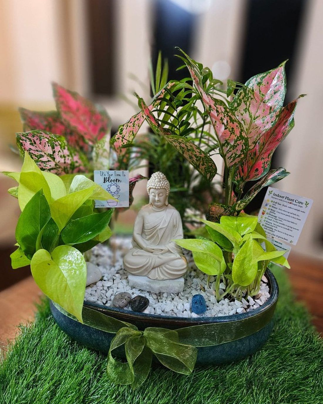 The Zen Sanctuary Planter — a seated Buddha among low green planting and pale gravel in a wide dark bowl.