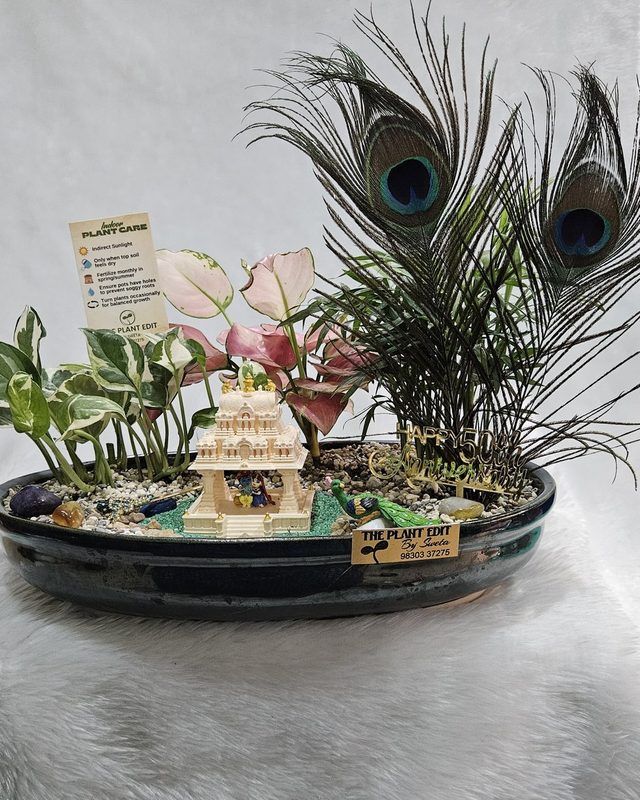A small temple form within planting and pale gravel.
